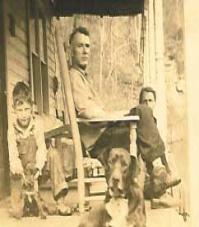 Family on porch after long day in the fields.  Dog keeping an eye on things.